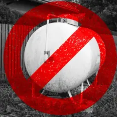 Zakaz ogrzewania gazowego z butli. Duży, biały zbiornik gazowy z czerwonym znakiem zakazu.